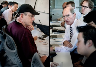 Photo by a Los Angeles corporate photographer showing a discussion of executives in a busy conference room