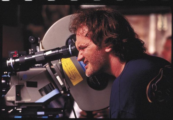 Quentin Tarantino writer of Django Unchained script on the set looking in movie camera