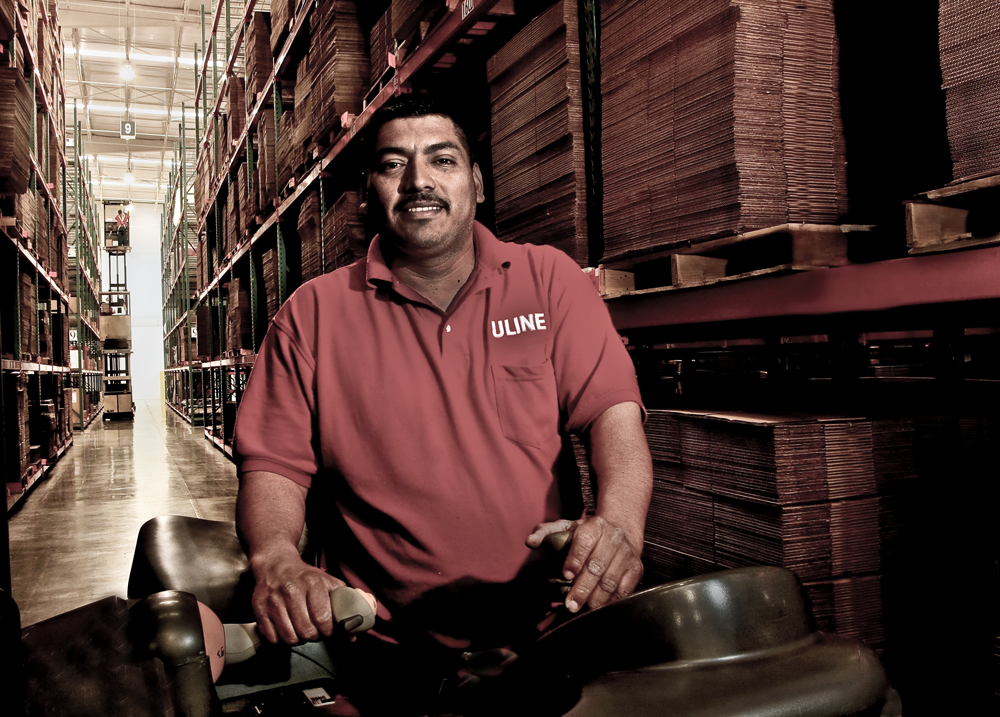 A forklift operator was photographed in Los Angeles warehouse for Uline corporate annual report publication