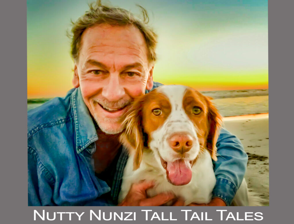 Man hugging his dog on Los Angeles beach at sunset